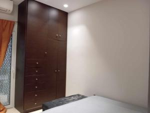 a bedroom with a bed and a large closet at The Genius apartment 3 rooms, Α floor 3 υπνοδωμάτια, A όροφος in Athens