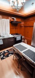 a kitchen with a table and a stove in it at C.-Habitación con baño privado / Centro de Coyoacan in Mexico City