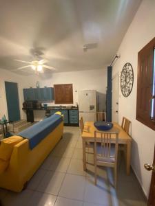 Una sala de estar con un sofá amarillo y una mesa. en La Casa Palmera - Caminito Del Rey, en Pizarra 39 fotos más