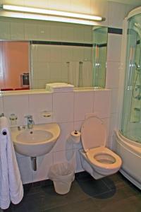 a bathroom with a toilet and a sink at Nest - Bundeststrasse 6-1br in Zug