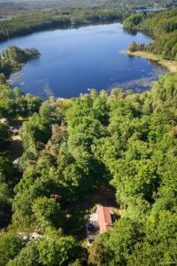 an aerial view of a lake with trees and a house at Stuga paradis in Orkelljunga
