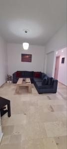 a living room with a blue couch and a table at Dimitra House Madouki Corfu in Mantoúkion +17 photos
