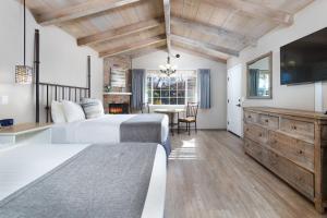 a bedroom with two beds and a television and a table at Sky Ranch Lodge in Sedona