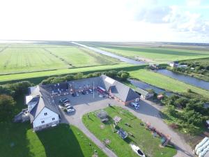 an aerial view of a large building next to a river at Hohenwarte in Højer