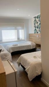 a room with two beds and a window at Apart IMEB spa & wellness in Río Cuarto