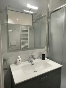 a bathroom with a sink and a mirror at Aura Apartments - Orizzonte Turismo in Porto Cesareo