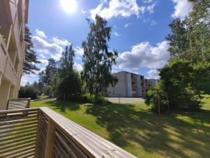 a view of a yard from a balcony of a building at New studio near amenities in Nilsiä