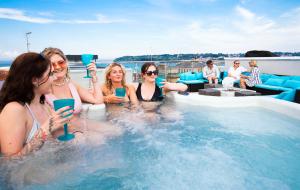 a group of women sitting in a hot tub at Seafarer's View - 6 bedroom townhouse in Cowes, parking & seaviews. in Cowes