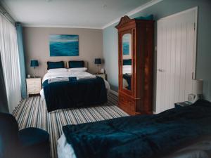 a bedroom with two beds and a dresser at Seafarer's View - 6 bedroom townhouse in Cowes, parking & seaviews. in Cowes