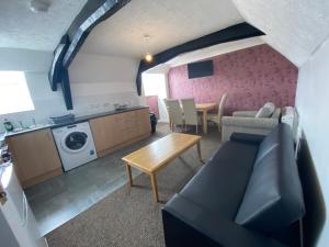 a living room with a couch and a table at Spacious One Bedroom Flat with River View, 1E in Great Yarmouth