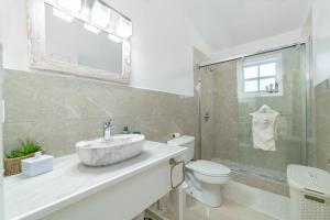 a bathroom with a sink and a toilet at Attractive 3-Bedroom Home - Harbour Breeze in Jolly Harbour +19 photos
