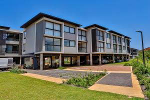 a large apartment building with a parking lot at Zimbali Lakes Boulevard Suites 218 in Ballito