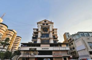 a building with a clock tower on top of it at Hotel Honey Bunny in Ahmedabad
