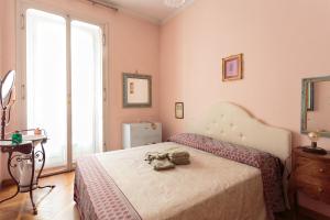 a bedroom with a bed with a purse on it at Vanchiglia Apartment - Torino in Turin