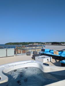 a hot tub on the roof of a building at Seafarer's View - 6 bedroom townhouse in Cowes, parking & seaviews. in Cowes