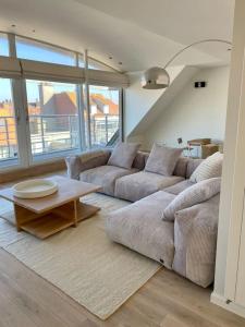 un soggiorno con un divano e un tavolino da caffè di Bellini - Rubensplein - op 100 m van het strand a Knokke-Heist