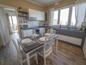 a kitchen and dining room with a table and chairs at Central Station Home - Fanale Rentals in Palermo