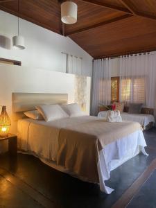 a bedroom with two beds and a window at Pousada Bambu Dourado in Marau