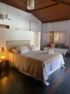 a bedroom with two beds in a room at Pousada Bambu Dourado in Marau