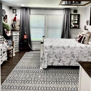 a bedroom with a bed and a rug at Pet Friendly Graham 2 Bedroom Home Christmas 365 at The Mistletoe Farm in Graham