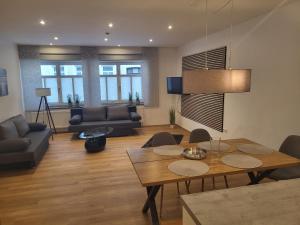 a living room with a wooden table and a dining room at Ferienwohnung an der Eiswiese in Ebern