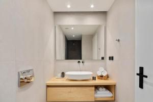 a bathroom with a sink and a mirror at Apartment Annunziata in Corfu Town