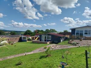 a view of a house with a yard at Eden Garden Luxury Lodges in Llangain