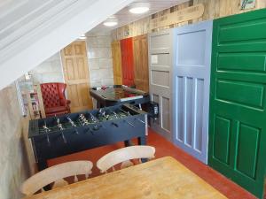 a kitchen with a table and a game room at Eden Garden Luxury Lodges in Llangain