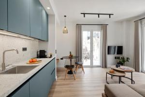 a kitchen with blue cabinets and a living room at Apartment Annunziata in Corfu Town +30 photos