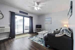 a living room with a couch and a window at Coastal Waters Life - 2nd Floor 1 Bedroom! in New Smyrna Beach