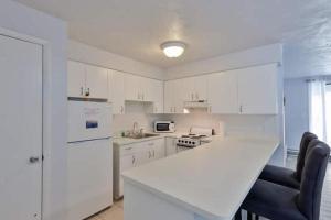 eine Küche mit weißen Schränken und einer weißen Arbeitsplatte in der Unterkunft Coastal Waters 210 - 2nd Floor 1 Bedroom With 2 Queen Beds in New Smyrna Beach