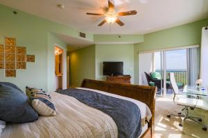 a bedroom with a bed and a ceiling fan at 3 Bedroom 2 Bath Oceanwalk Condo With Estuary Views in New Smyrna Beach