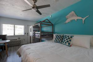a bedroom with a bed with a ceiling fan at Pineapple Pad Studio At Coastal Waters 105 in New Smyrna Beach