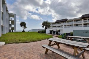 a picnic bench in front of a building at Pineapple Pad Studio At Coastal Waters 105 in New Smyrna Beach