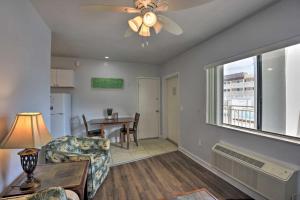 a living room with a ceiling fan and a table at Coastal Waters 108-109- 2 Bedroom 2 Bath Pool Side Condo! in New Smyrna Beach