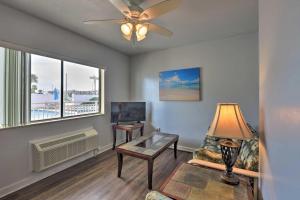 a living room with a ceiling fan and a table at Coastal Waters 108-109- 2 Bedroom 2 Bath Pool Side Condo! in New Smyrna Beach