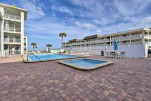a swimming pool in front of a building at Coastal Waters 108-109- 2 Bedroom 2 Bath Pool Side Condo! in New Smyrna Beach