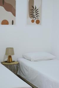 a bedroom with two beds and a table with a lamp at Casa M Montenegro in Donji Morinj