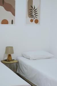 Un dormitorio con dos camas y una mesa con lámpara. en Casa M Montenegro, en Donji Morinj