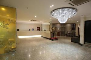 a large lobby with a large chandelier in a building at Taiwan Hotel in Ribeirão Preto