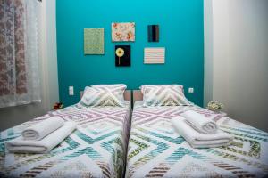 a bedroom with two beds with towels on them at Lithos apartments in Kalymnos