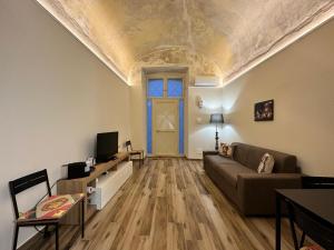 a living room with a couch and a ceiling at Agathae Home in Catania