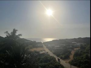 a view of a beach with the sun in the sky at CASA in Cape Coast