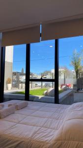 a large bed in a bedroom with a large window at Apart IMEB spa & wellness in Río Cuarto +85 photos