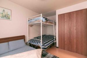 a bedroom with two bunk beds and a bed at Dream Misono - Vacation STAY 14778 in Sapporo