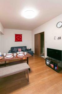 a living room with a couch and a table at Dream Misono - Vacation STAY 14778 in Sapporo