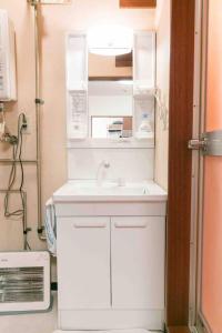 a small kitchen with a sink and a refrigerator at Dream Misono - Vacation STAY 14777 in Sapporo