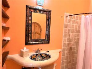 a bathroom with a sink and a mirror at Villa Amor in Sayulita