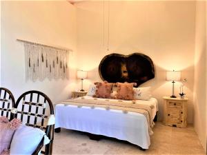 a bedroom with a bed with a large headboard at Villa Amor in Sayulita