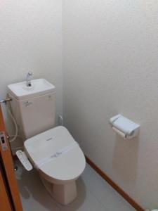a bathroom with a white toilet and a toilet paper dispenser at Restful Tsukuda - Vacation STAY 14829 in Aomori